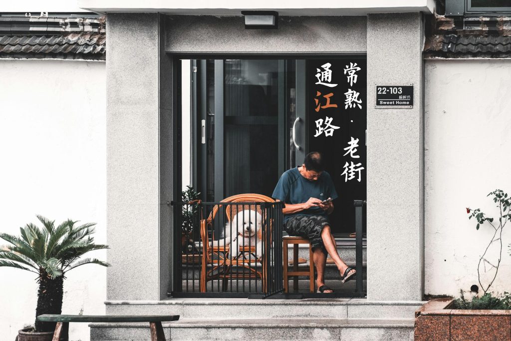 Man Sitting with Dog on Balcony - pet proof a small balcony