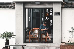 Man Sitting with Dog on Balcony - pet proof a small balcony