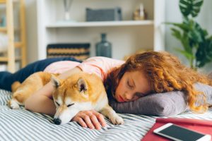Redhead Woman Sleeping with Dog - Tire out your dog inside